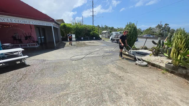 UP 2 Cleaning crew pressure-cleaning the concrete forecourt at Uncle George’s Coffee Shop in Banora Point
