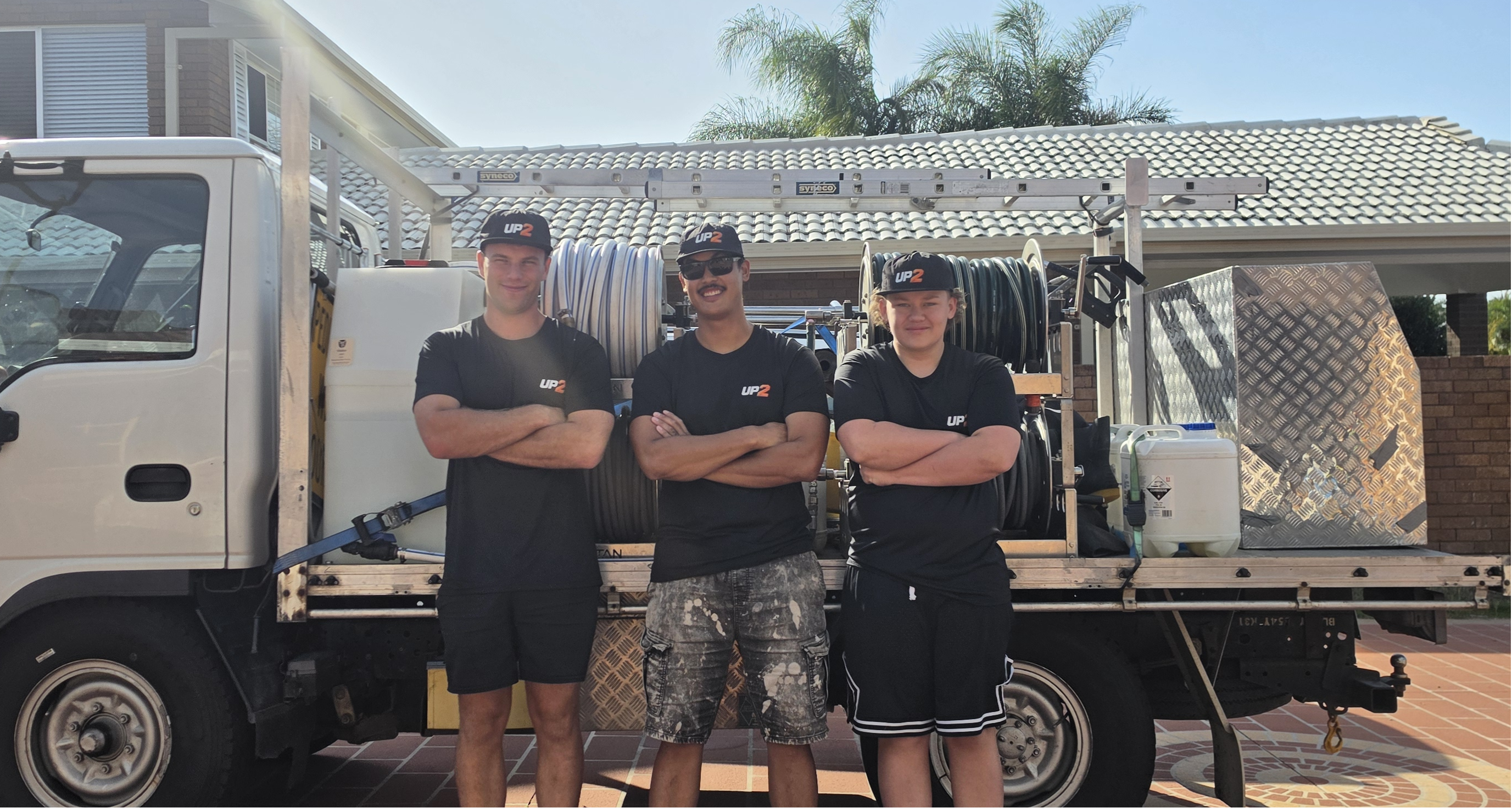 Three UP 2 Cleaning team members in front of their pressure cleaning truck